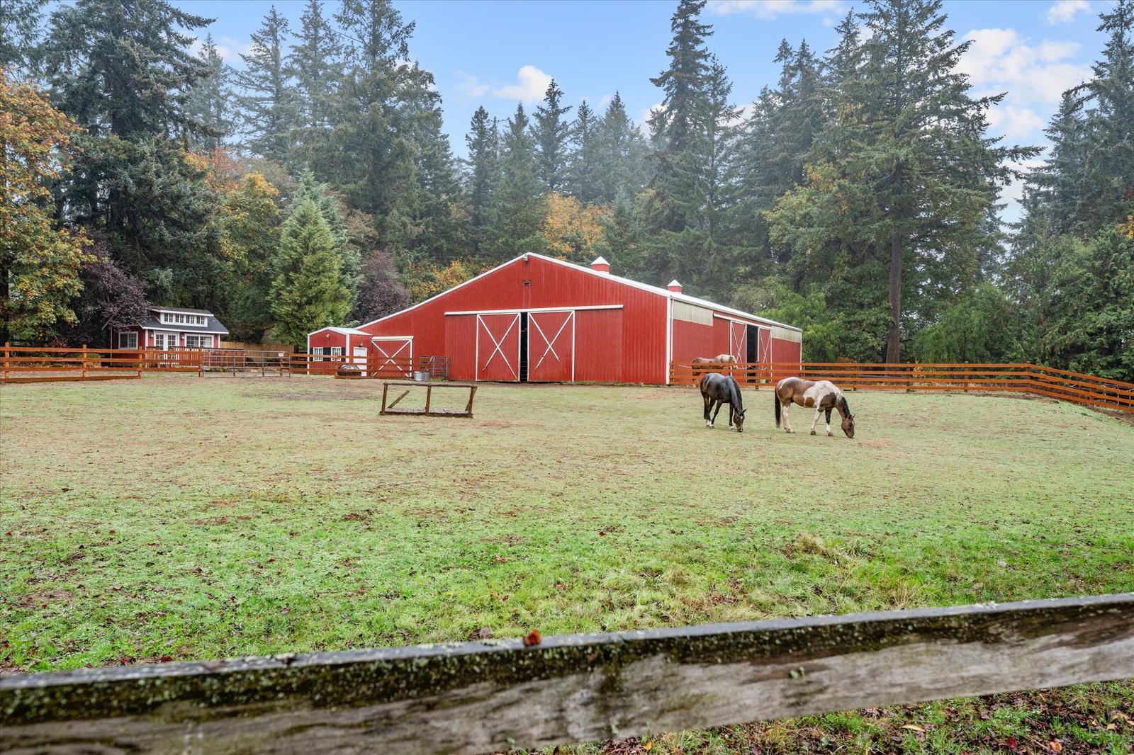 Red barn and pasture with horses